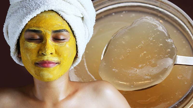 How to Make Your Own Sea Moss Face Mask - woman with turmeric mask and a white towel wrapped around her head like in a spa, with a jar of sea moss gel in the background