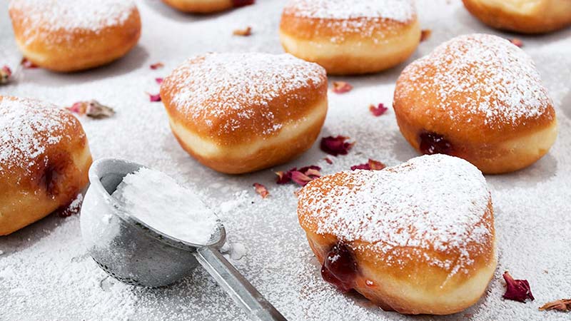 What Are The Side Effects Of Detoxing From Sugar? - powdered hot jam donuts on a table -