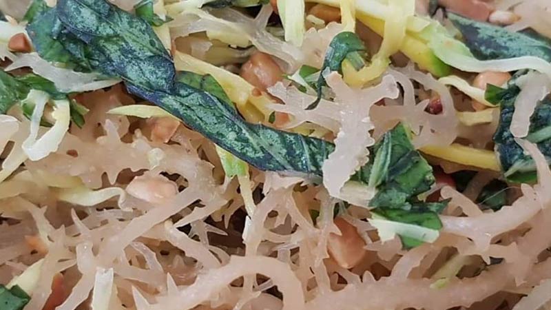 Sea Moss salad made from rehydrated sea moss that has been sun bleached to change the color to a golden, almost light fawn. Dressed with fried kang kong and tossed with toasted peanuts