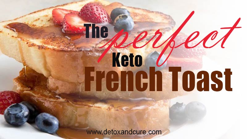 The Perfect Keto French Toast Recipe - image of a stack of golden brown french toast covered in a generous drizzle of maple syrup on a white plate which has been garnished with sliced strawberries and whole blueberries