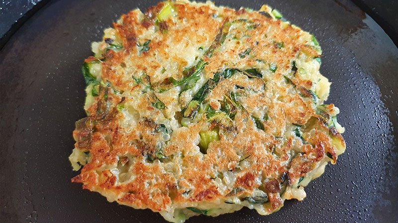 cooking-second-side-pan-fry-cooking-zucchini-fritters-with-sea-moss-on-a-timber-chopping-board