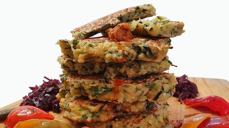 feature-cooked-and-served-zucchini-fritters-with-sea-moss-on-a-timber-chopping-board